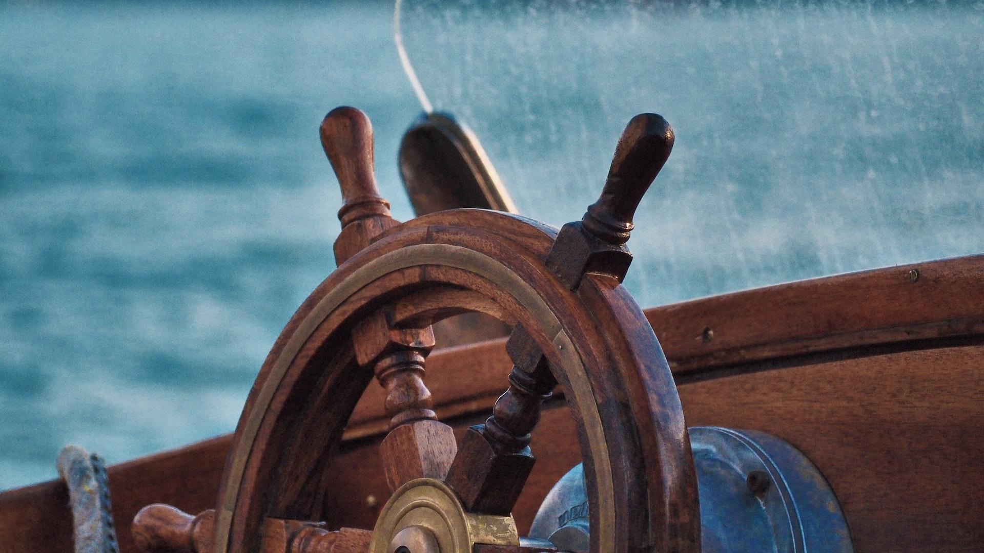 brown wooden ship steering wheel